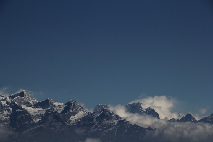 Panoramic view of the Himalayas with snow-capped peaks.
