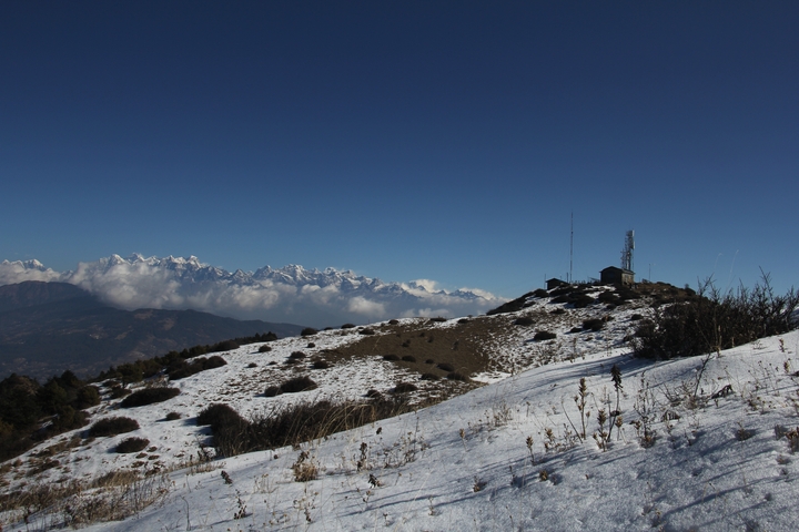 Snowy landscape with distant mountain peaks.