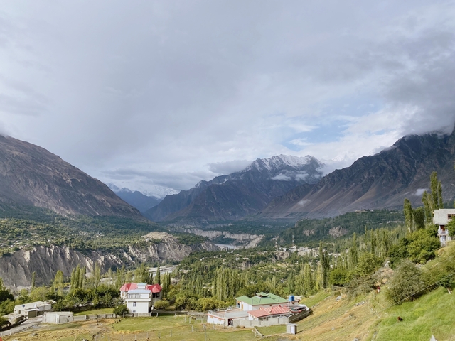       Mountainous landscape with green valleys and cloudy sky.
  
