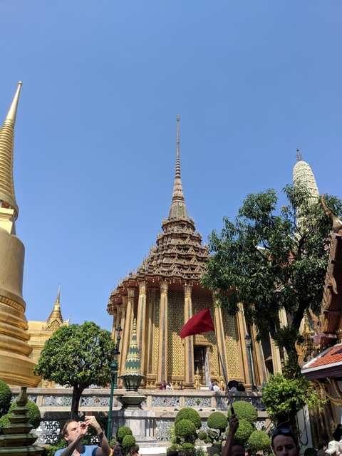 Ornate traditional architecture with a spire against a clear blue sky.