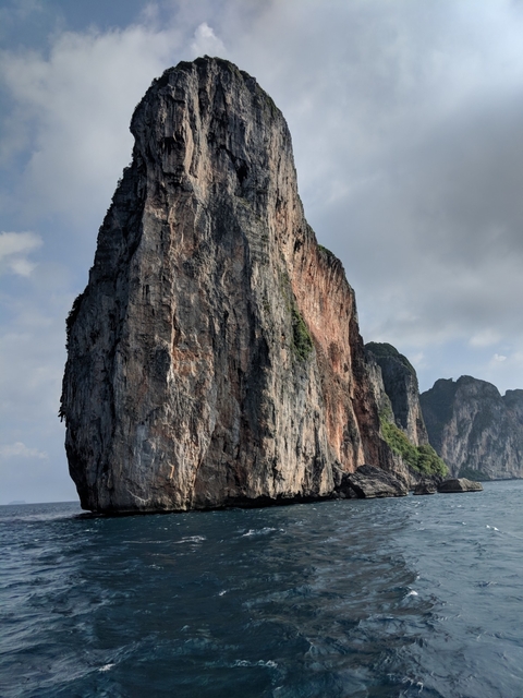Tall rocky cliffs along a coast, viewed from the water level.