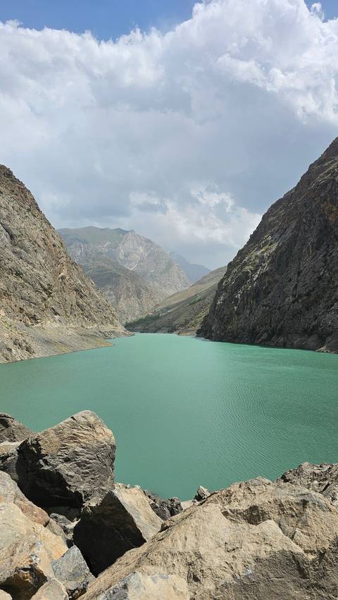      Scenic view of a clear lake surrounded by rocky cliffs.
  