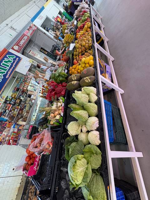 A market stall showcasing a variety of fresh vegetables and fruits.