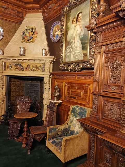 Interior view with ornate wood carvings and decorations.