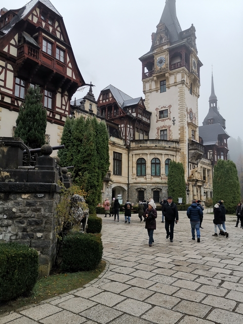       People walking near castle-like building.
  