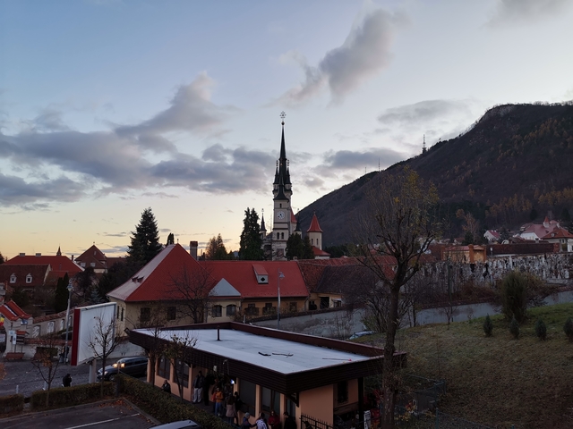       Beautiful sunset view over a town with a church steeple.
  