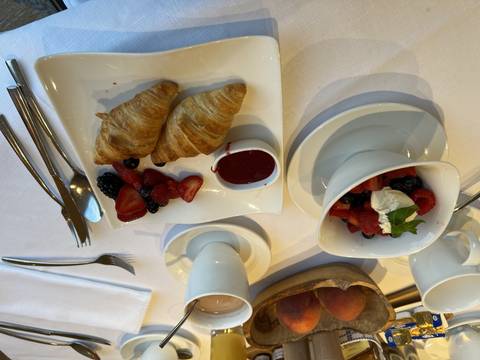 Continental breakfast with croissants and berries.