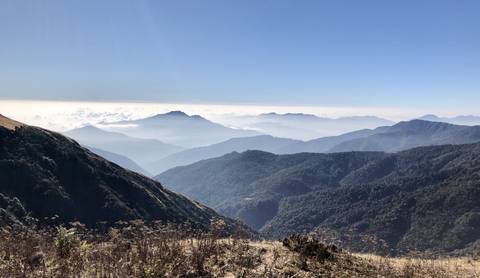 Mountain range with some clouds in the sky.