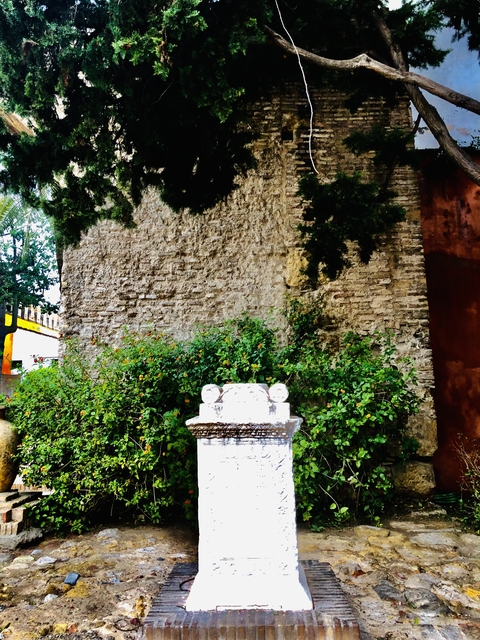 A garden with a decorative stone object.