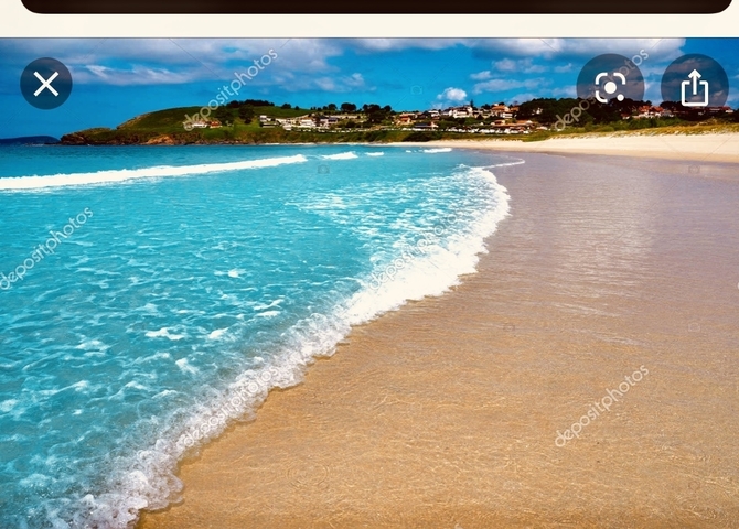       Beach scene with calm waves and a watermark.
  