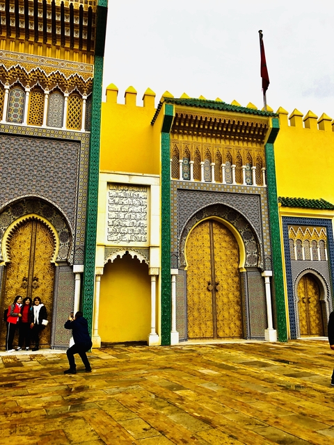 Intricately designed gates with golden doors.