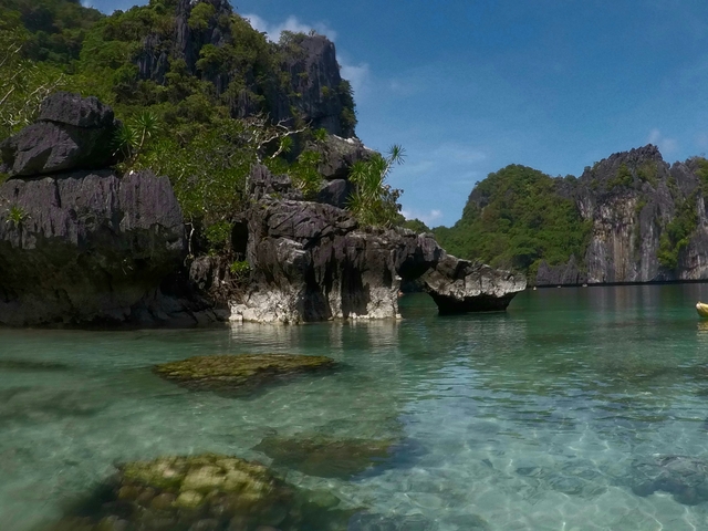 Idyllic coastal landscape with rocky outcrops and clear water.