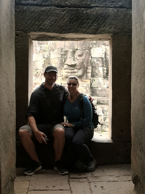       Couple posing inside ancient ruins.
  