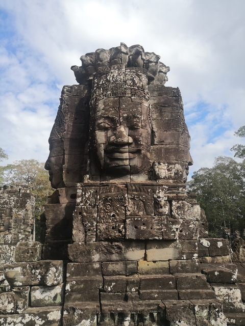       Large stone face carved into a temple structure.
  