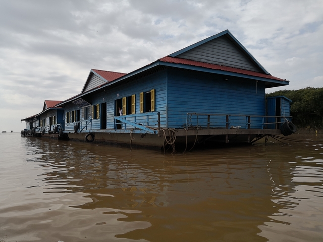       Floating houses on a body of water.
  