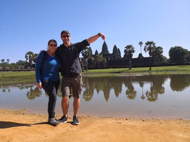       Couple posing with Angkor Wat in the background.
  