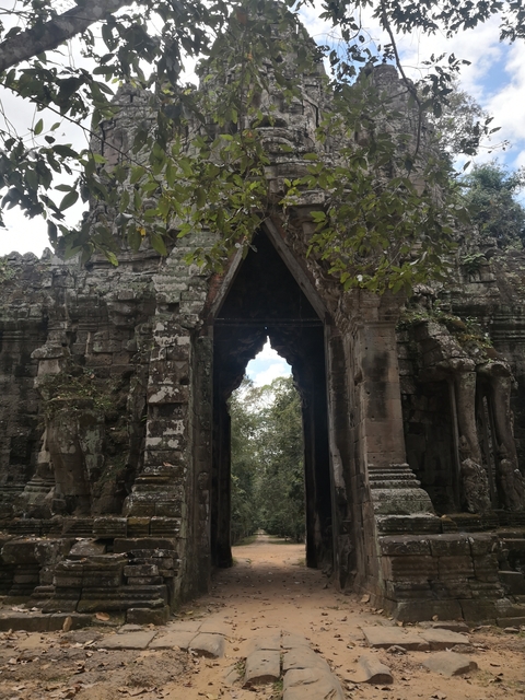      Ancient temple gate with trees in the background.
  
