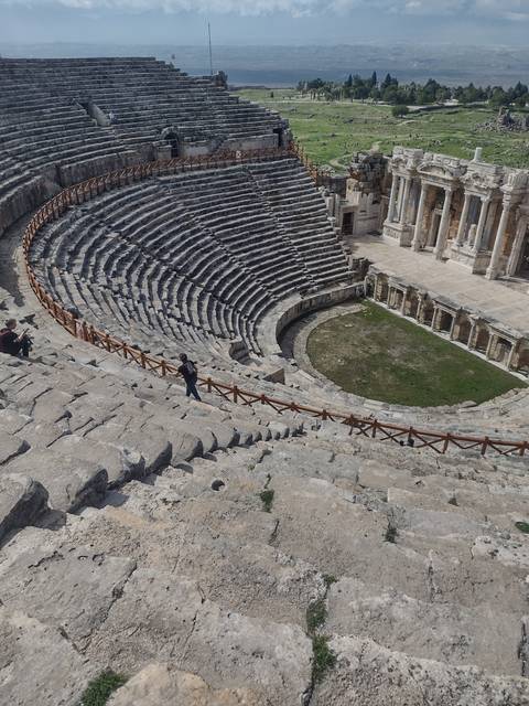       Ancient amphitheater with stone seating.
  