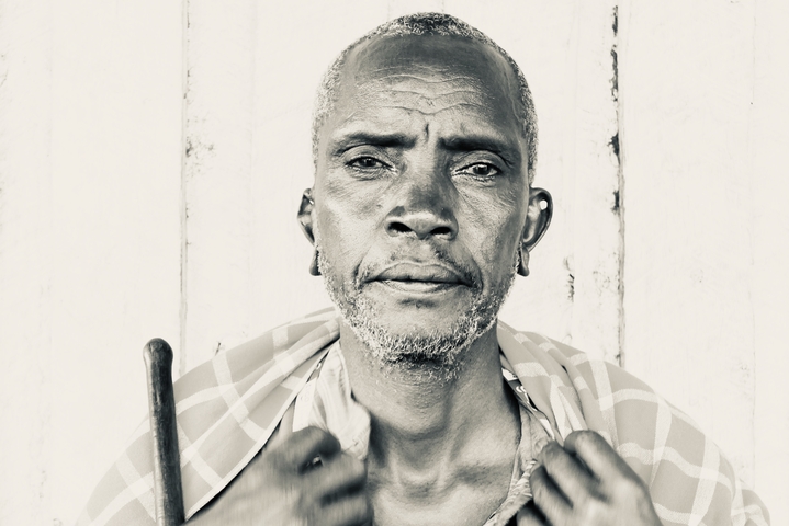       Black and white portrait of an elderly man.
  