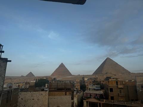 An upside-down view of pyramids and surrounding landscape.