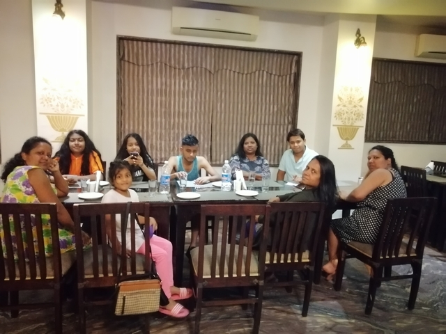 Group dining indoors around a table.