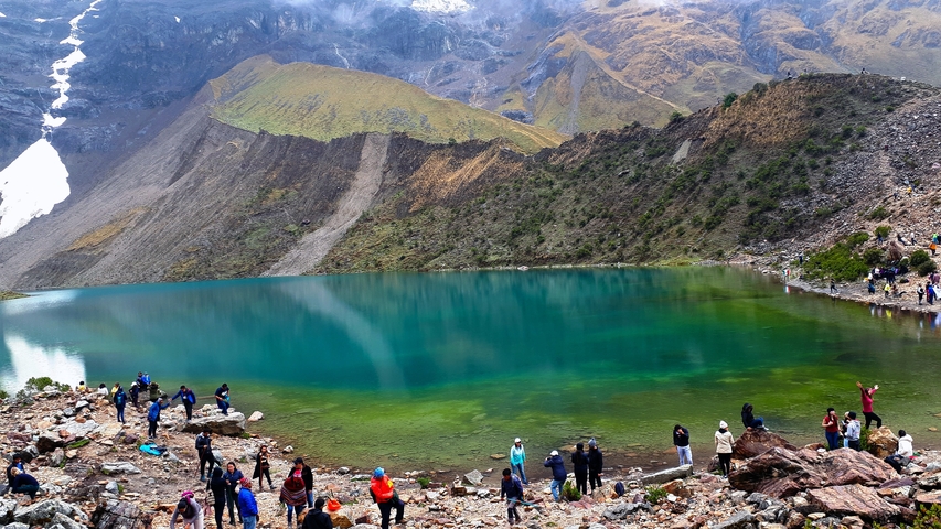 Crystal-clear turquoise lake surrounded by mountains.