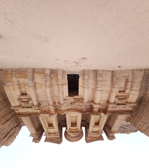 Facade of an ancient structure with columned entrance.
