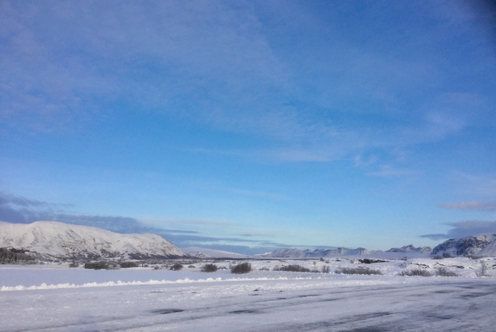 Open snowy expanse under a clear blue sky.