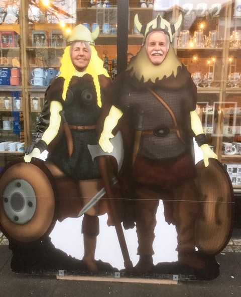 A shop display with cartoon Viking characters holding shields.