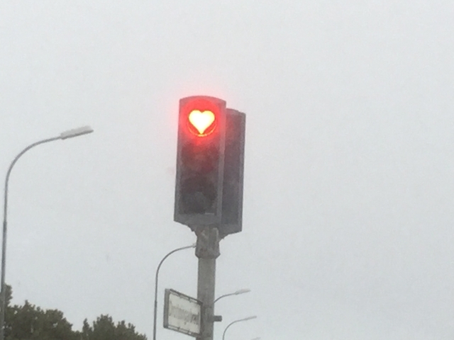 Traffic light with a red heart-shaped light.