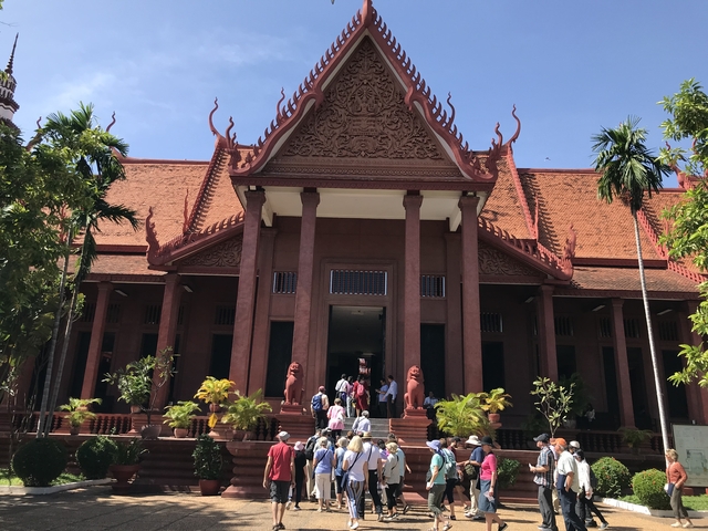 A temple with visitors standing at the entrance.