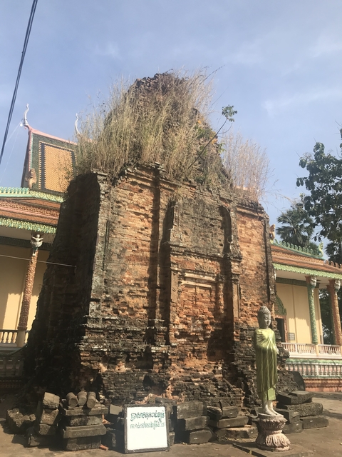       Ancient brick structure surrounded by vegetation.
  