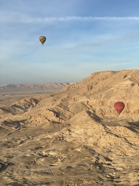       Hot air balloon over a desert landscape.
  