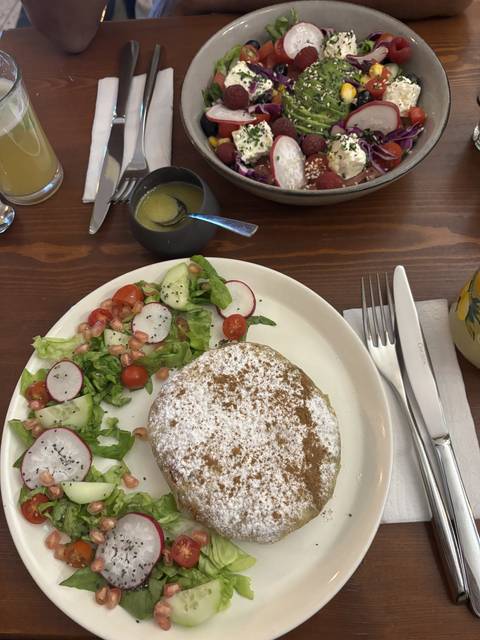 Close-up of a plate with food, including a salad and a main dish.