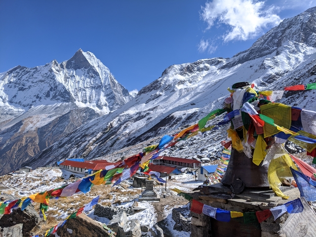 Mountains with prayer flags and buildings.