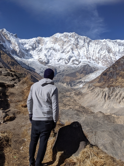 Person overlooking a mountainous landscape.