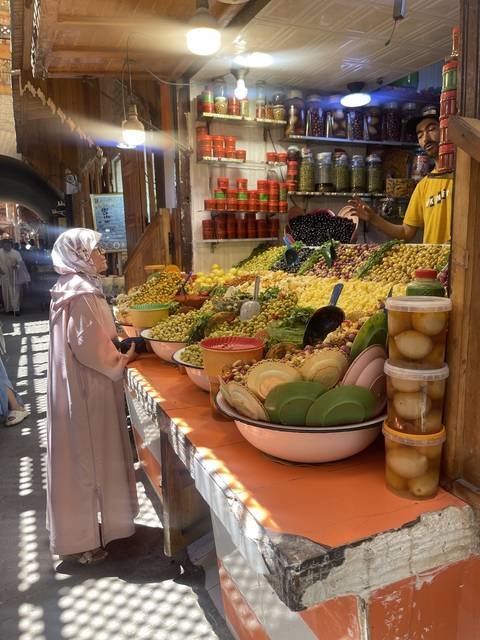       A vibrant market stand with a variety of colorful goods and foods.
  
