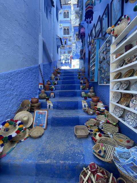 A shop with vibrant blue decor showcasing various crafts.