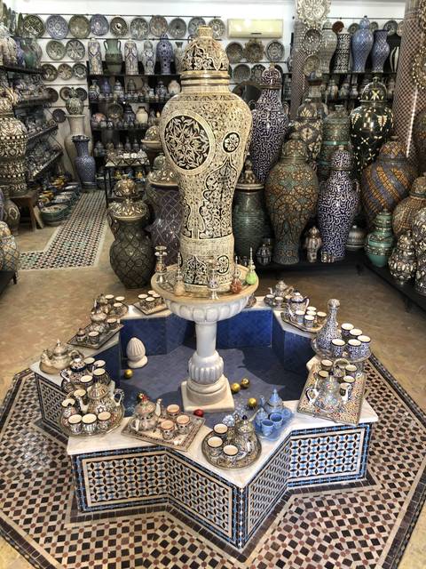       Display of ornate pottery in a shop.
  