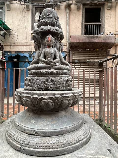       A stone statue with intricate carvings.
  
