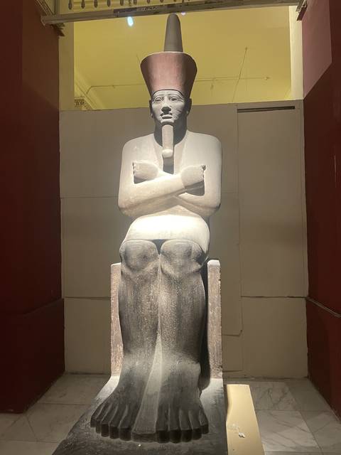       Statue of an Egyptian pharaoh inside a museum.
  
