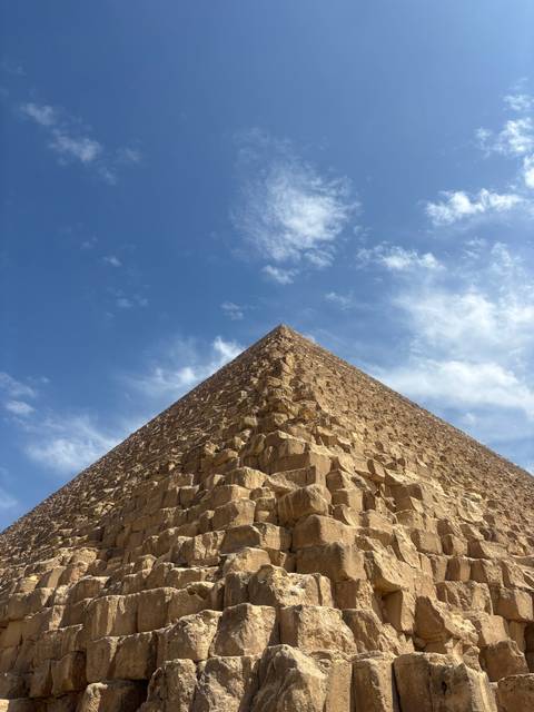 Close-up of pyramid stones against a blue sky.