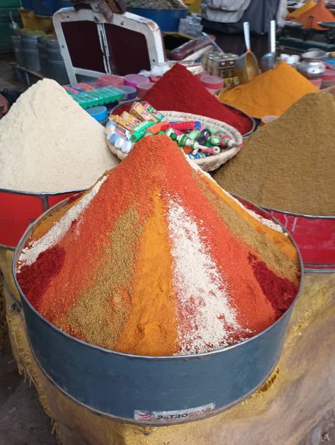       A colorful pile of spices in a market.
  