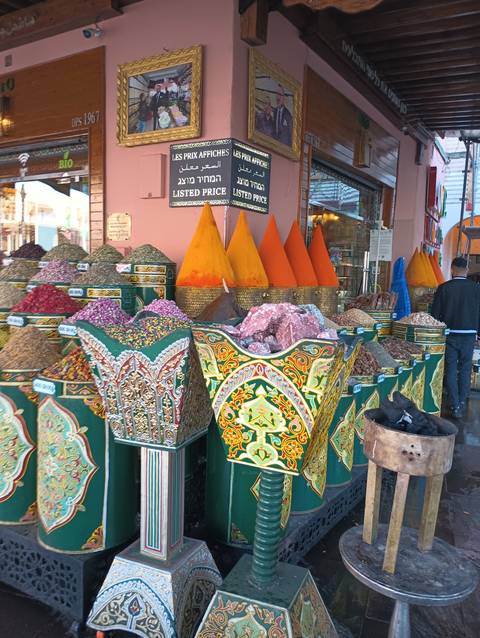       A market stall with colorful spices and herbs.
  