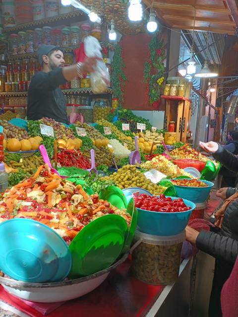       A food market stall with various fresh produce.
  