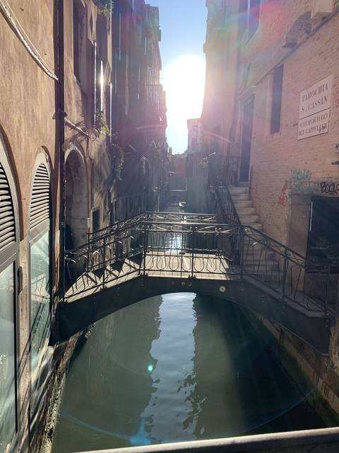       Narrow canal in a city with traditional buildings.
  