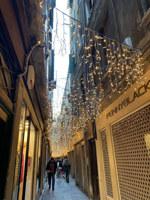       Street with holiday lights decorating the buildings.
  