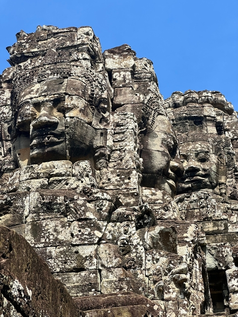 Multiple carved stone faces in a historic site.
