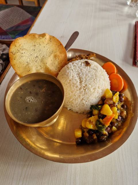       Traditional meal with rice, curry, and soup.
  