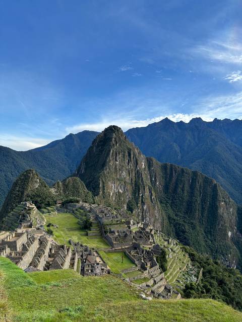 View of Machu Picchu ruins with mountains.